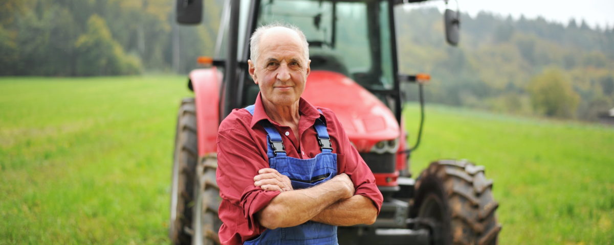 farmer standing in front of tractor