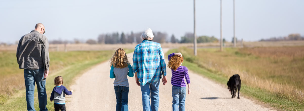 Family Walking Down Rural Gravel Driveway