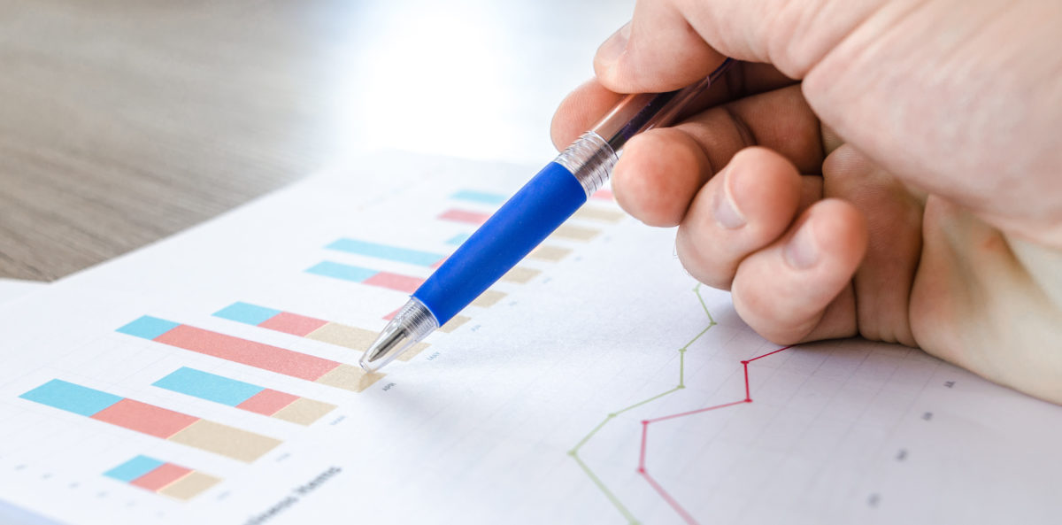 Man looking at graph on wood table