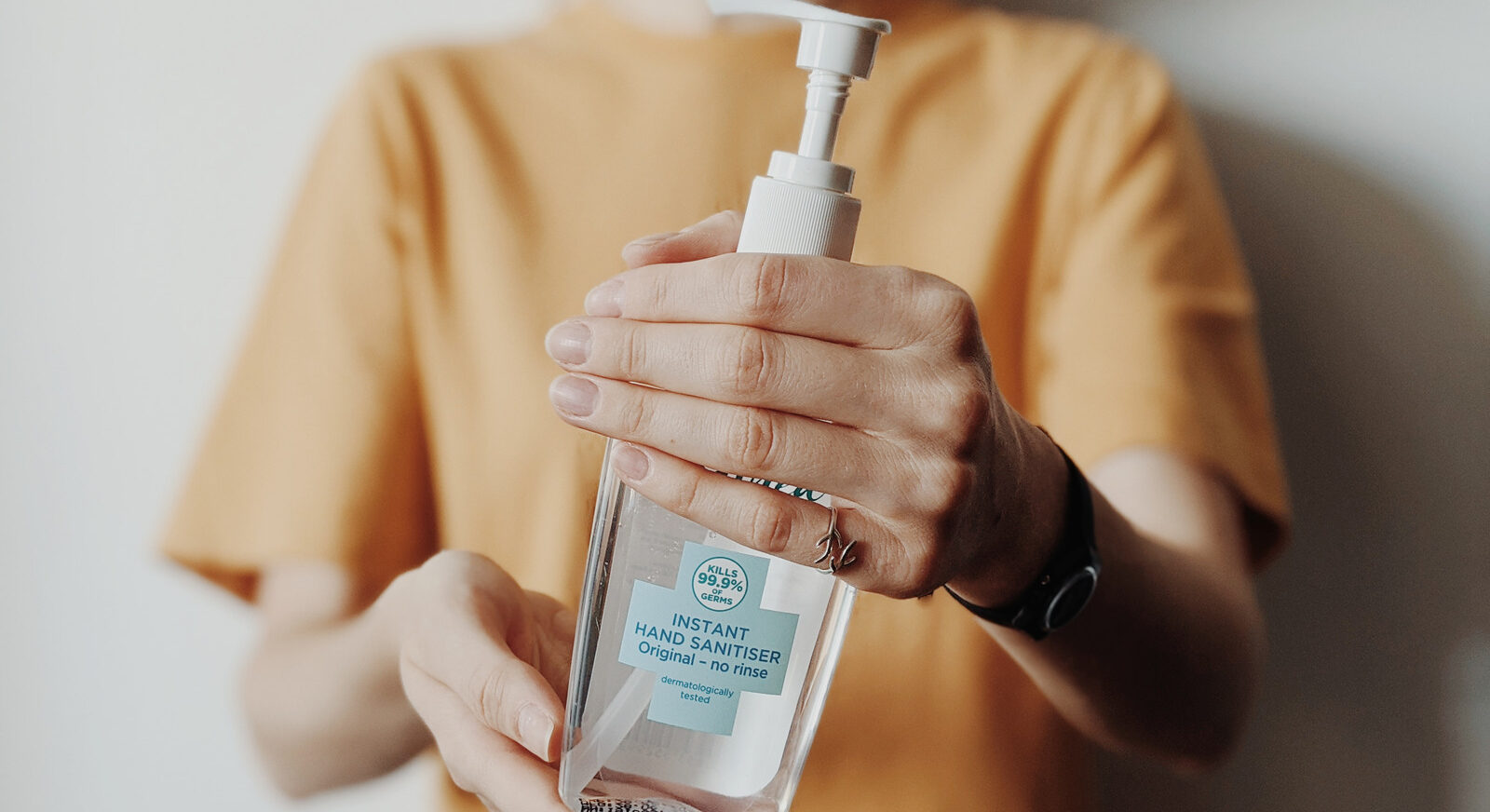 woman holding hand sanitizer