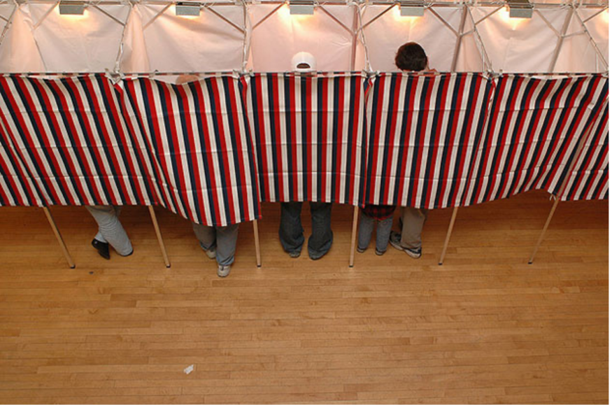 Voters standing in voters booths