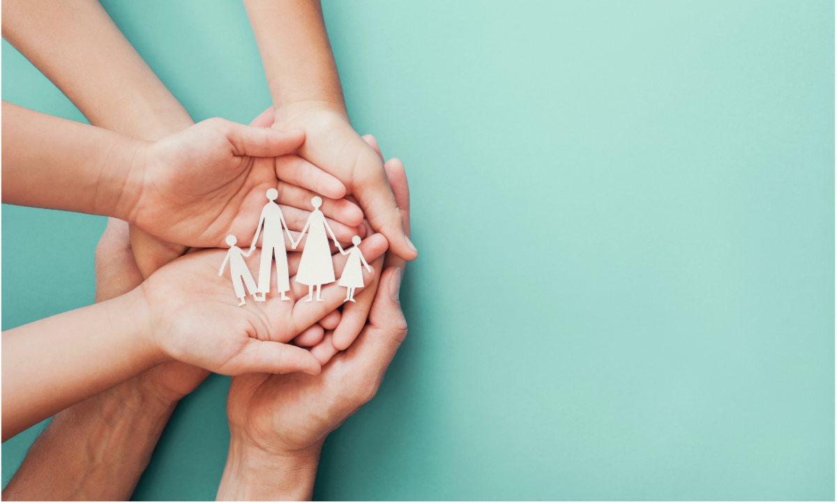 Hands holding a family cut out from paper